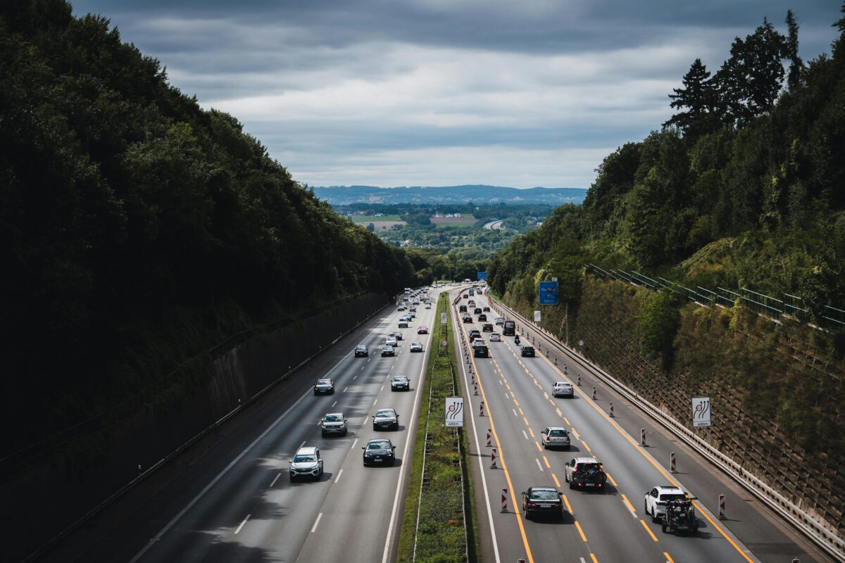 Autobahn alemana durante una ruta en coche por Alemania Tráfico circulando por una autopista en Alemania rodeada de bosque